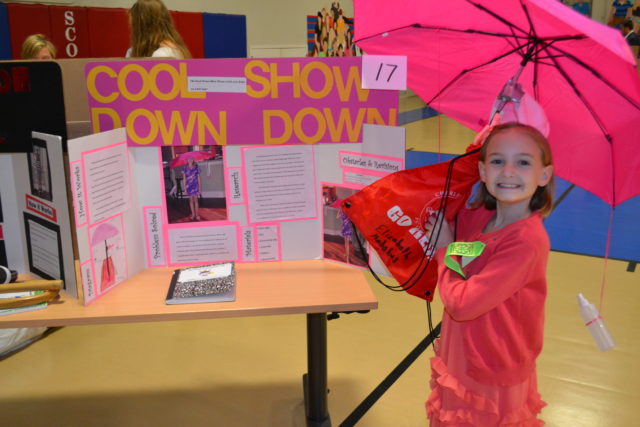 student presents her science fair exhibit