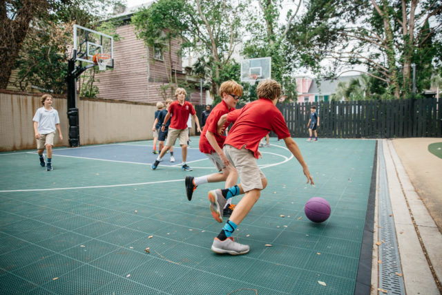 students play basketball during recess