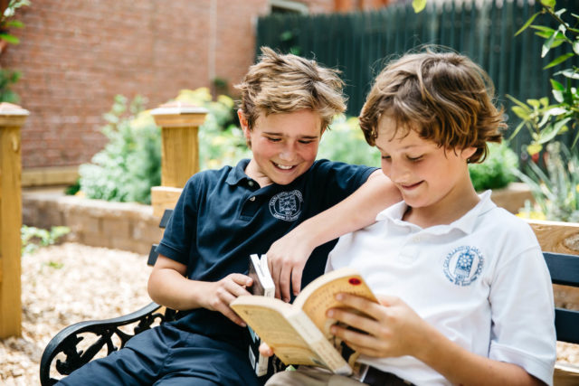 boys read books outdoors
