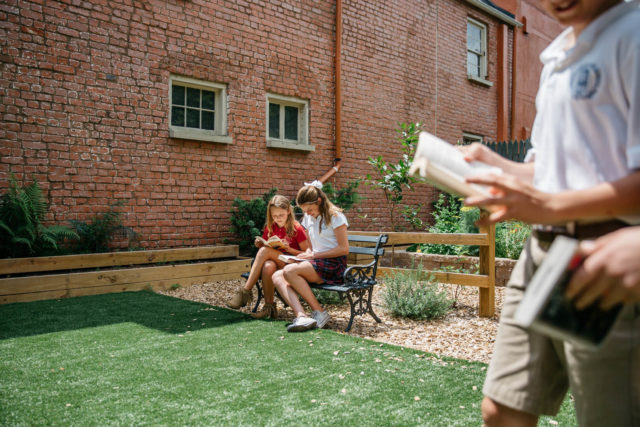 students read outdoors in garden