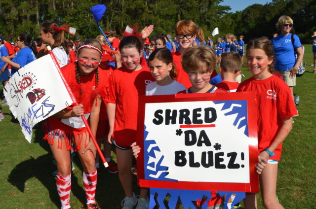 red team displays sign during field day