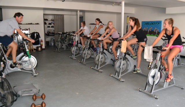 teacher gives spin class with students