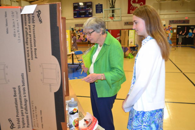 student shows science fair project