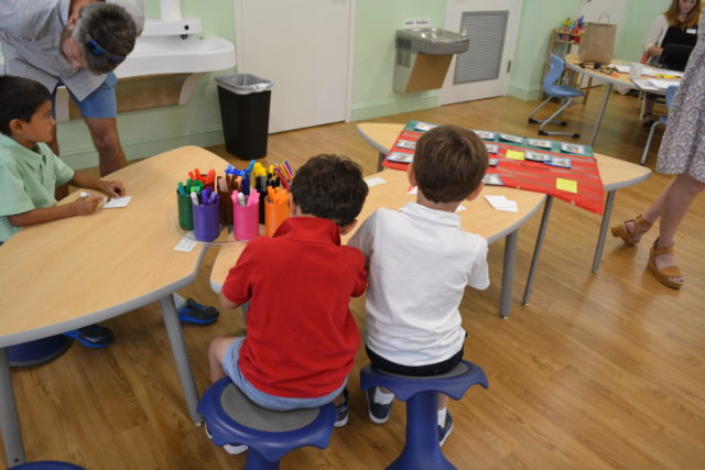 kindergarten students work at a table