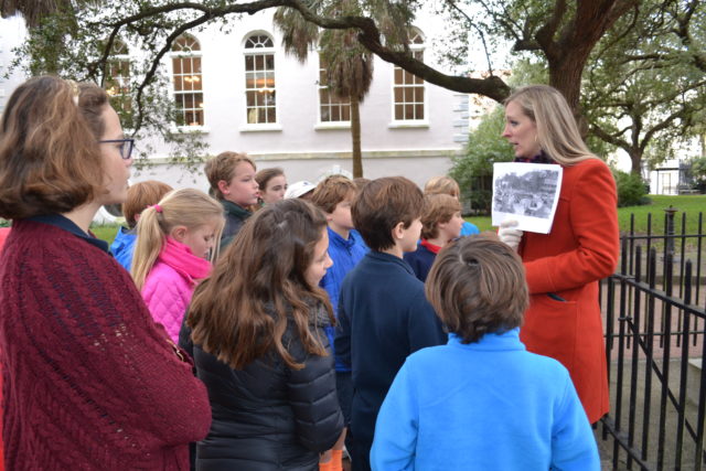 teacher instructs students during charleston history field trip