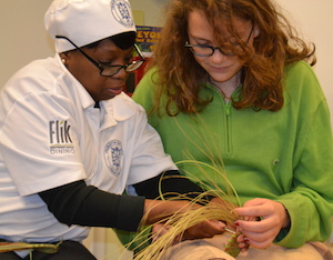 student learns basket weaving with sweetgrass