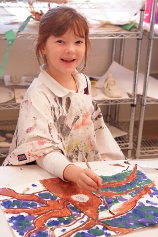 smiling girl painting